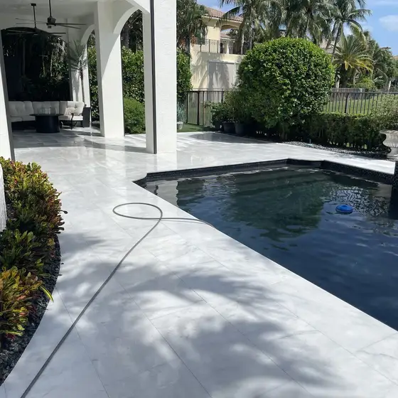 White stone pool deck and covered terrace, cleaned